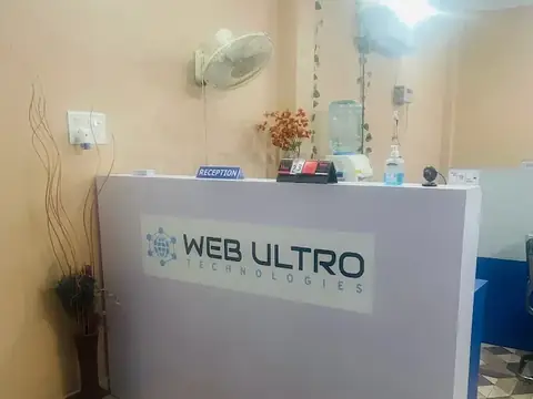Reception desk with the Web Ultro logo at the Webultro Training institute